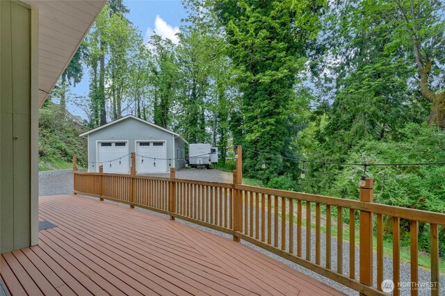 deck with an outbuilding and a detached garage