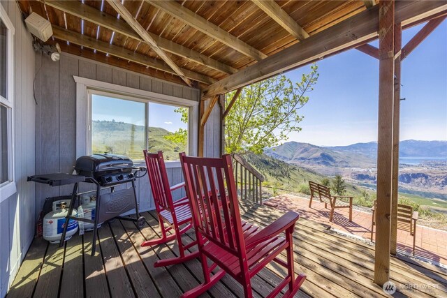 wooden terrace with a mountain view and a grill
