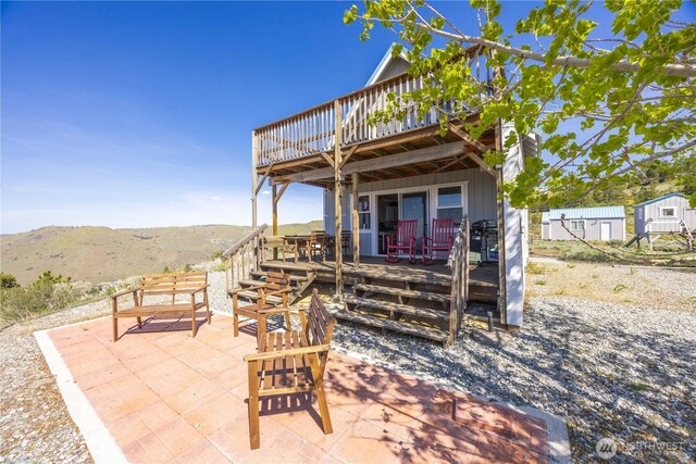 view of patio with a deck with mountain view