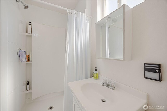 bathroom with vanity and a stall shower