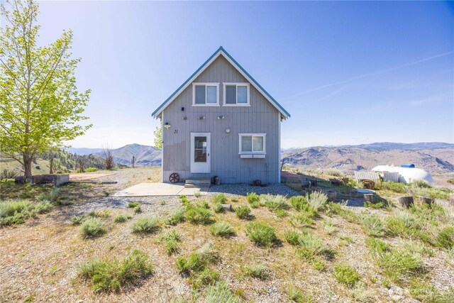 rear view of property with a mountain view and a patio