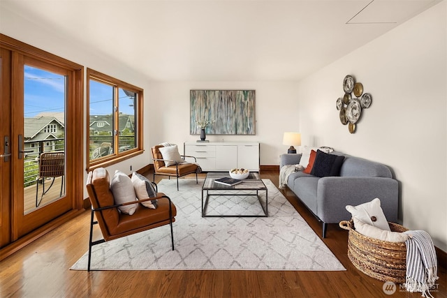 living area featuring wood finished floors and baseboards