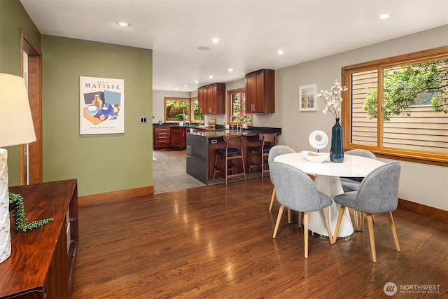 dining space with wood finished floors, baseboards, and recessed lighting