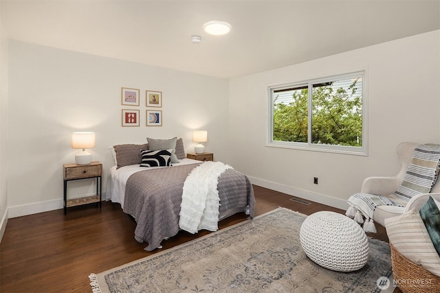 bedroom featuring baseboards and wood finished floors