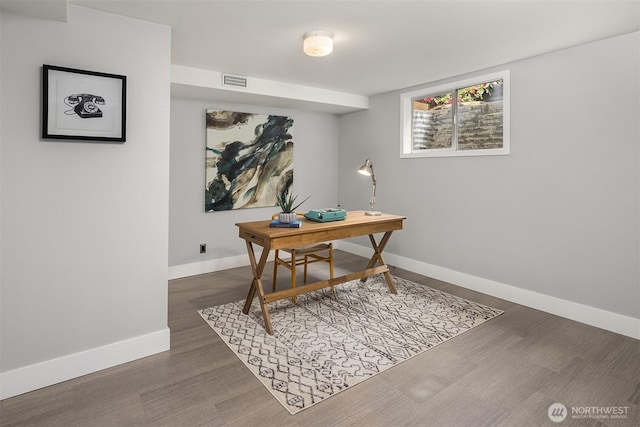 office space with baseboards and dark wood finished floors