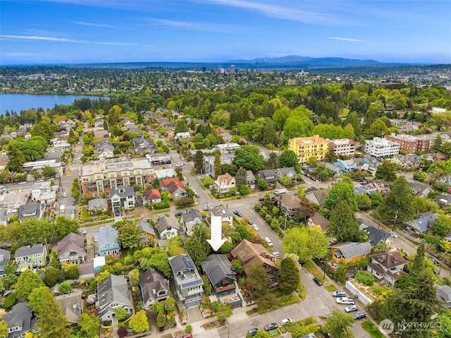 aerial view of residential area featuring a water and mountain view