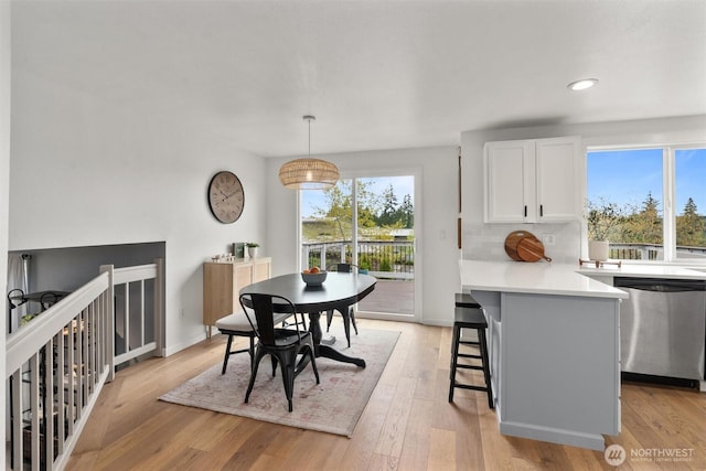 dining area with light wood-style floors, baseboards, and recessed lighting