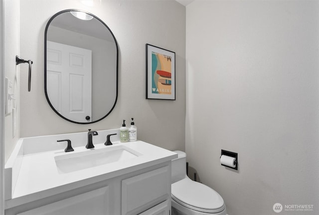 bathroom featuring vanity and toilet