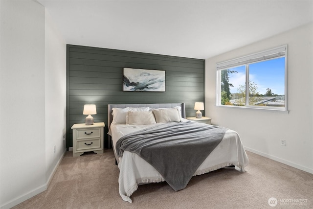 bedroom with baseboards and carpet