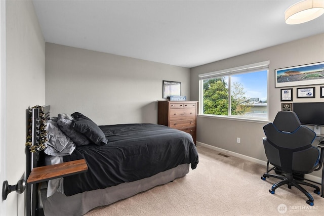 bedroom with baseboards, carpet flooring, and visible vents