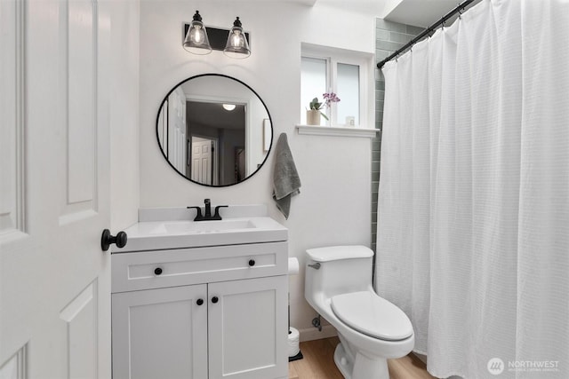 full bath with vanity, toilet, wood finished floors, and a shower with shower curtain