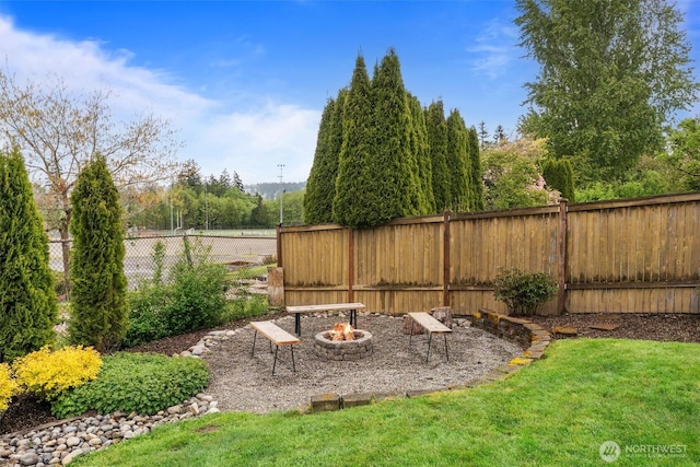 view of yard with a fenced backyard and an outdoor fire pit