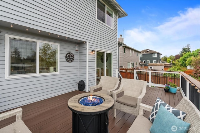 wooden terrace featuring a fire pit