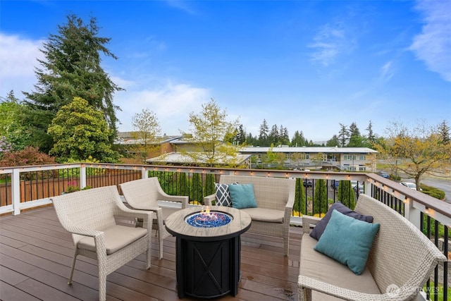 wooden deck with a fire pit
