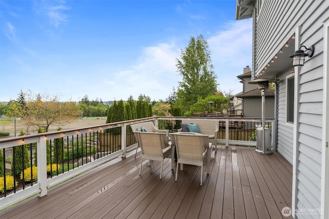 wooden terrace with outdoor dining space