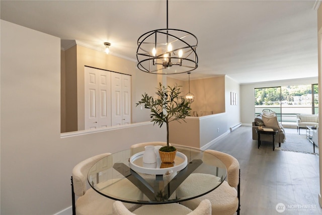 dining area with an inviting chandelier, baseboards, crown molding, and wood finished floors