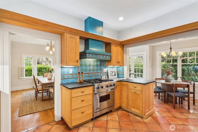1238 E Newton St, Seattle, WA 98102 - kitchen featuring a chandelier, designer stove, custom exhaust hood, dark countertops, and recessed lighting