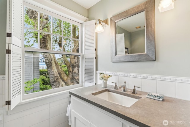 1238 E Newton St, Seattle, WA 98102 - bathroom featuring vanity, wainscoting, and tile walls