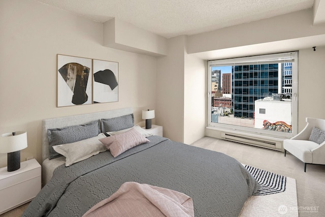 bedroom featuring a textured ceiling and baseboard heating