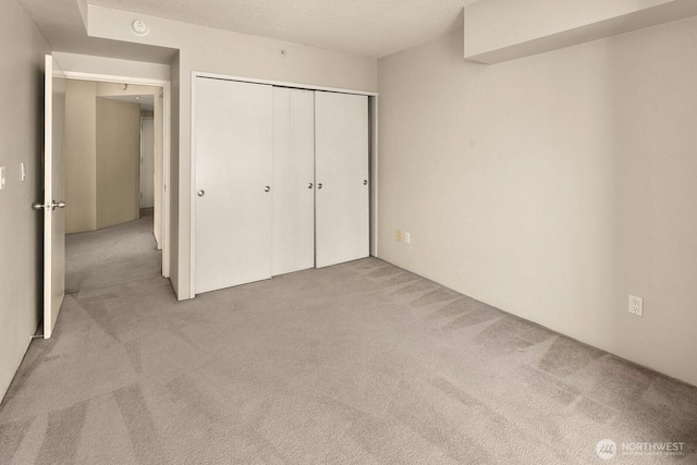 unfurnished bedroom with carpet floors and a closet