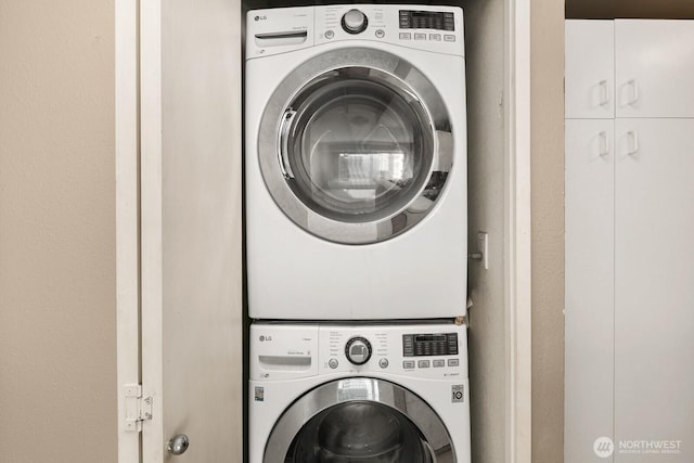 washroom featuring laundry area and stacked washer and clothes dryer