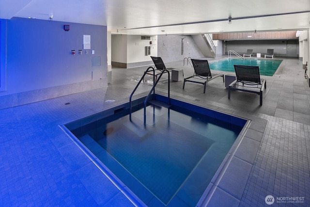 community pool featuring a patio area