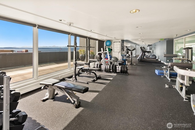 gym with a water view and recessed lighting