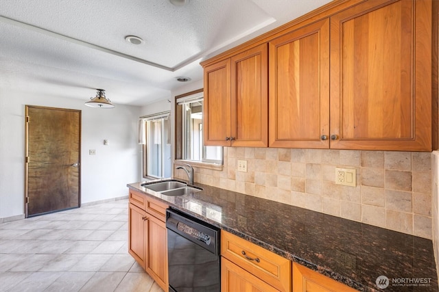 kitchen with a sink, brown cabinetry, backsplash, and dishwasher