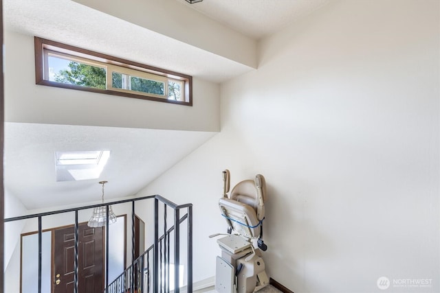 interior details featuring a skylight and baseboards