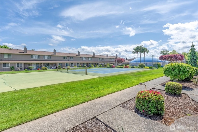 surrounding community featuring a lawn, fence, and a residential view