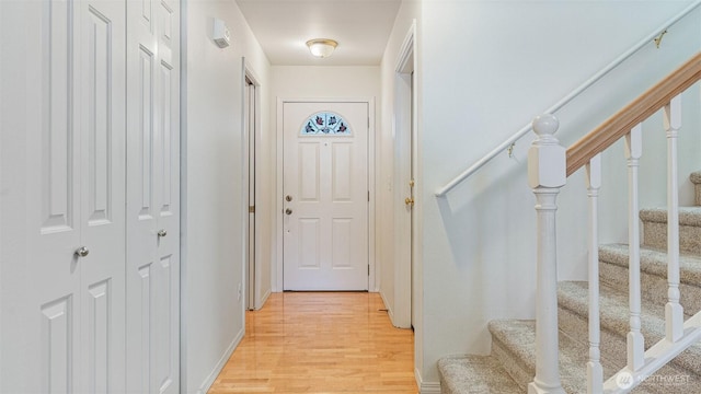 entryway featuring stairs and light wood-type flooring