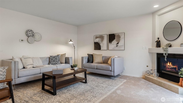 living room with light colored carpet, baseboards, a glass covered fireplace, and recessed lighting