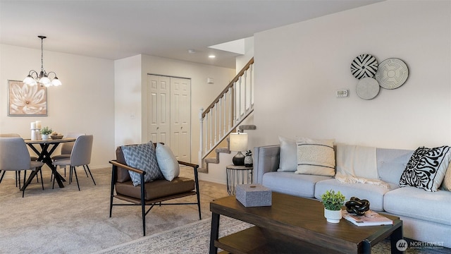 living room with an inviting chandelier, baseboards, light carpet, and stairs