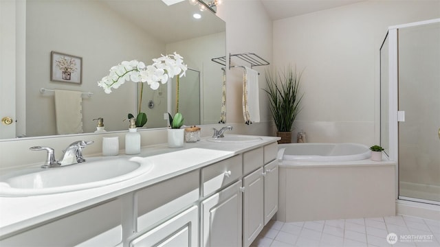 bathroom with a sink, double vanity, a shower stall, and a garden tub