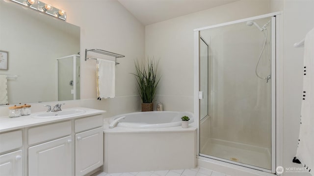 bathroom with vanity, a garden tub, and a stall shower