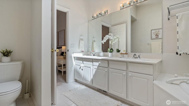 bathroom featuring double vanity, a sink, visible vents, and toilet