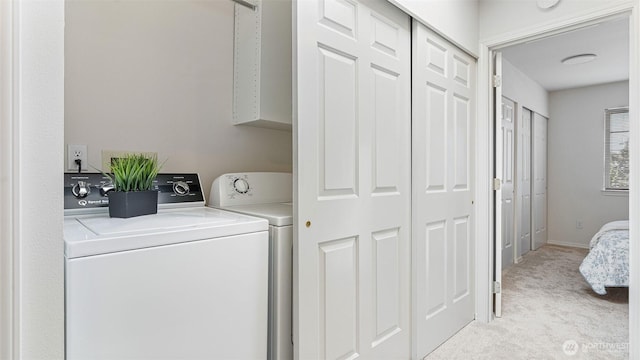 laundry room with baseboards, washing machine and clothes dryer, and light colored carpet