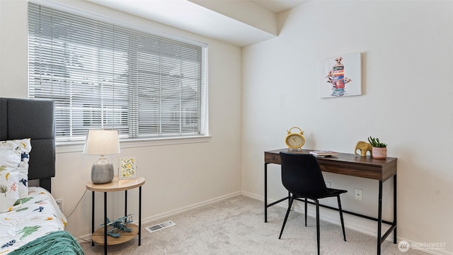 home office with visible vents, baseboards, plenty of natural light, and carpet floors
