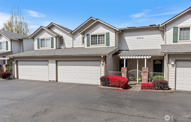 view of front of property featuring a garage and aphalt driveway