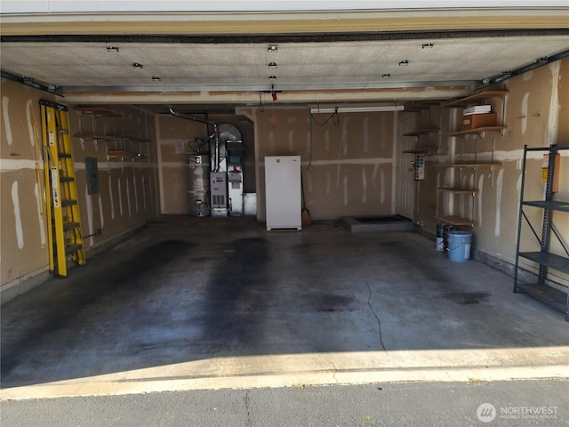 garage featuring secured water heater and freestanding refrigerator