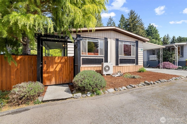 view of outdoor structure featuring fence and ac unit