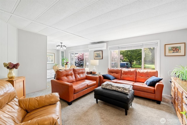 living area with a wall unit AC, a chandelier, and light colored carpet