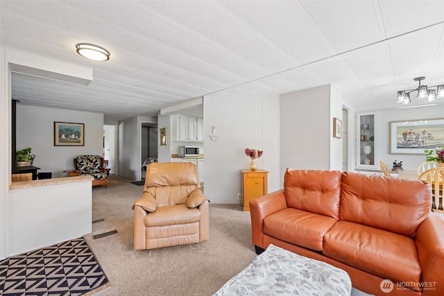 living area featuring carpet floors and a notable chandelier