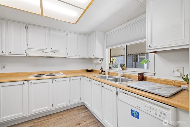 kitchen featuring white appliances, light countertops, under cabinet range hood, white cabinets, and a sink