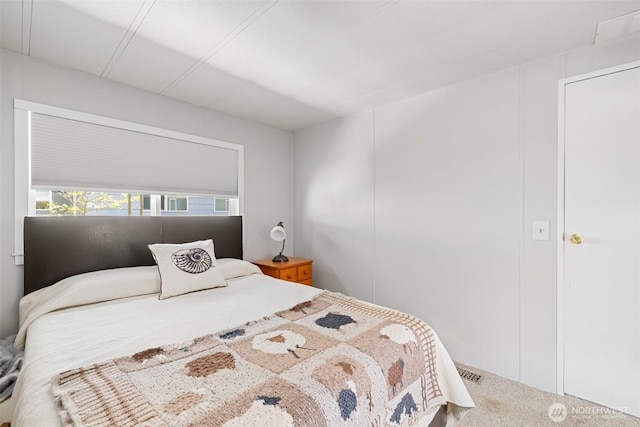 bedroom with carpet floors and visible vents