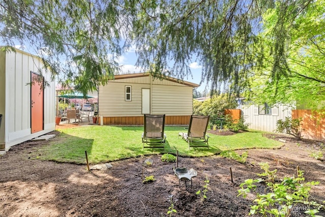 view of yard featuring an outdoor structure and fence