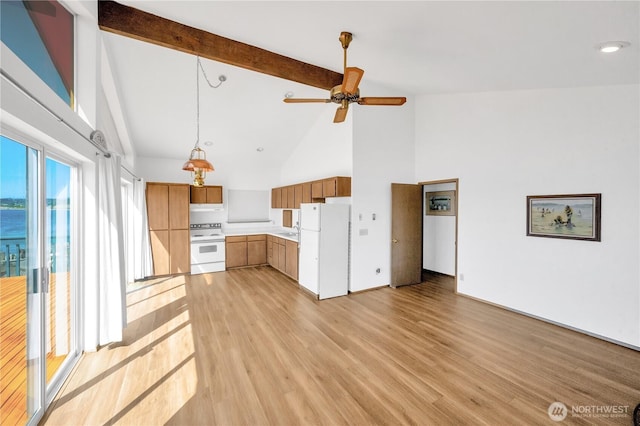 1409 Fossil Ln, Oak Harbor, WA 98277 - kitchen with beam ceiling, white appliances, ceiling fan, high vaulted ceiling, and light countertops