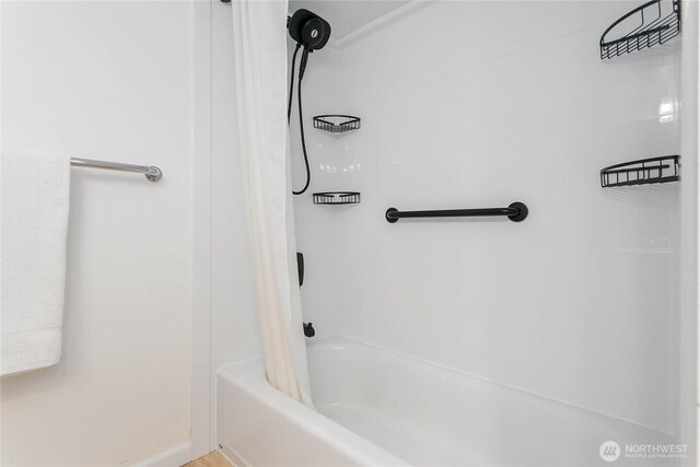 full bathroom featuring baseboards and shower / bath combo with shower curtain