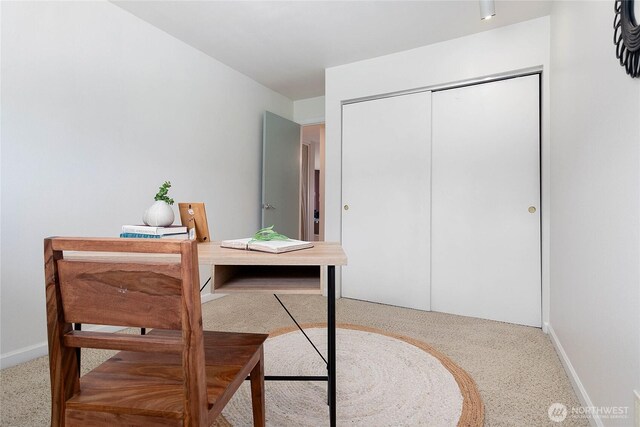 carpeted office featuring baseboards