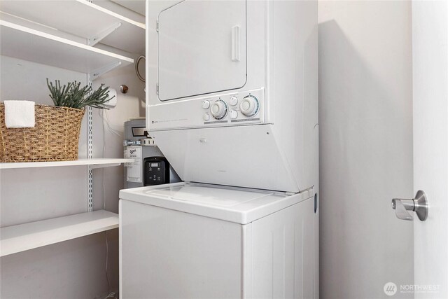 laundry area featuring laundry area and stacked washer / dryer